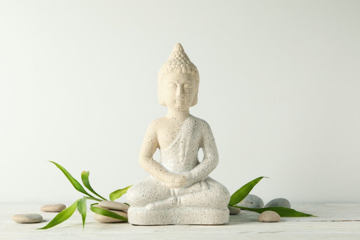 Buddha and stones on wooden table. Zen concept