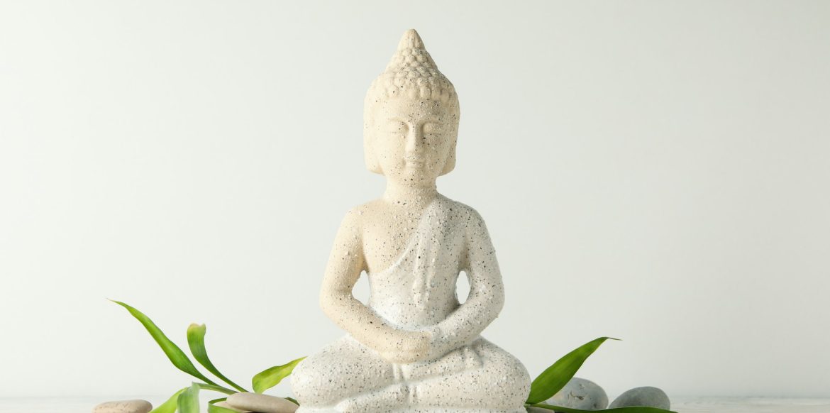 Buddha and stones on wooden table. Zen concept