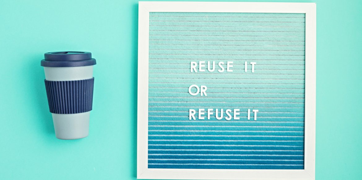 Reusable coffee cup and letterboard with text reuse it or refuse it. Zero waste sustainable